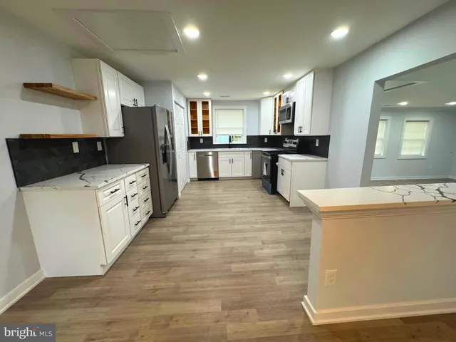 an empty room with windows and chandelier