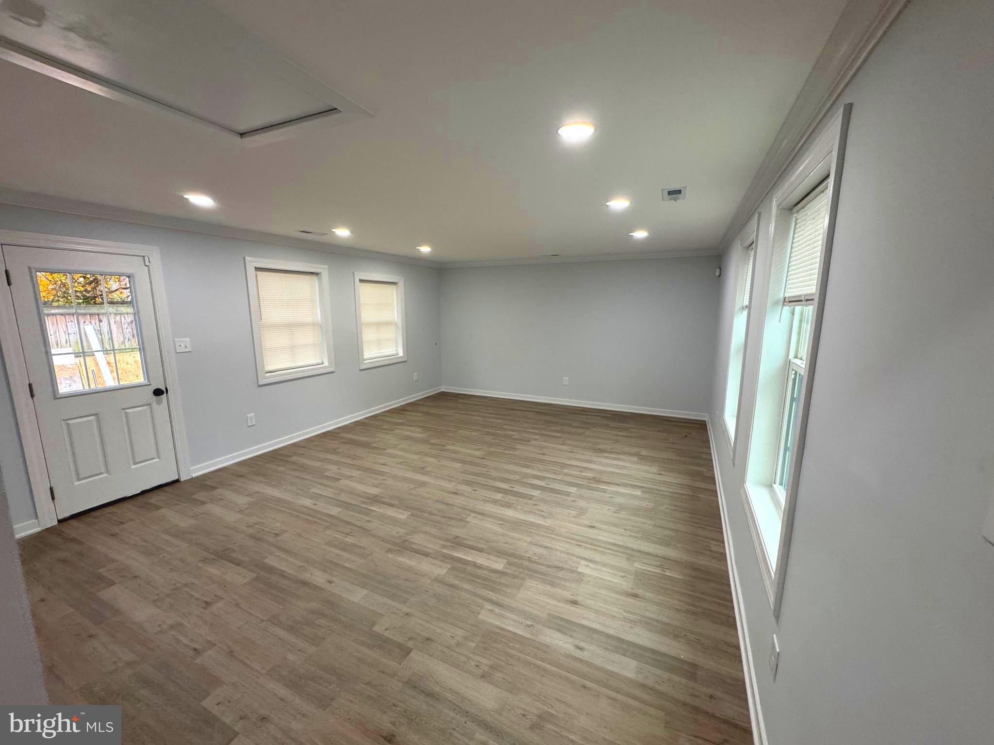 203 Henson Road Glen Burnie, MD 21060 - Photo 41 of 44 an empty room with wooden floor and windows