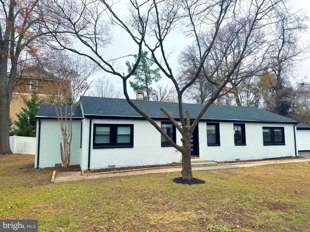 a view of a house with a large tree