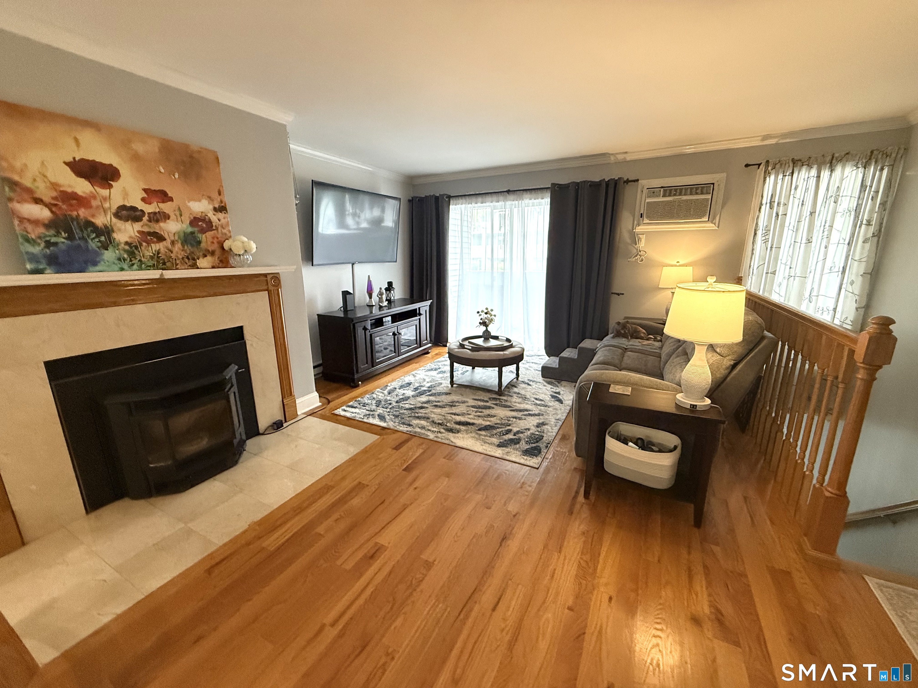 1 Beaver Brook Road, Unit 50 Danbury, CT 06810 - Photo 1 of 1 Fireplace with pellet stove and hardwood flooring.