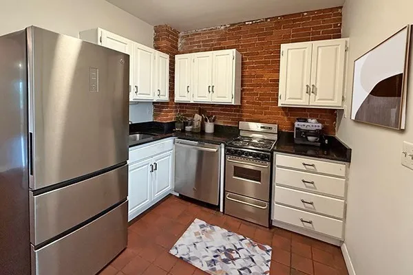 a kitchen with stainless steel appliances a refrigerator sink and cabinets