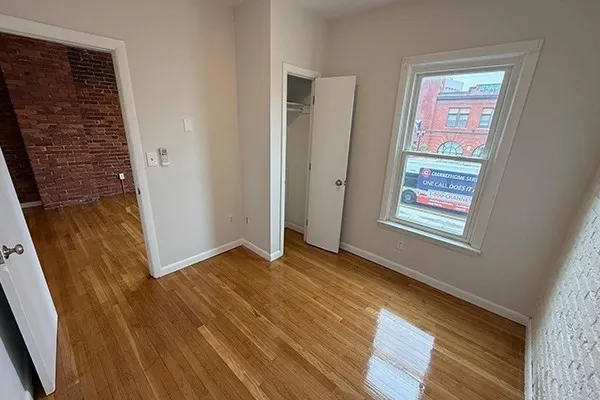 wooden floor in an empty room with a window
