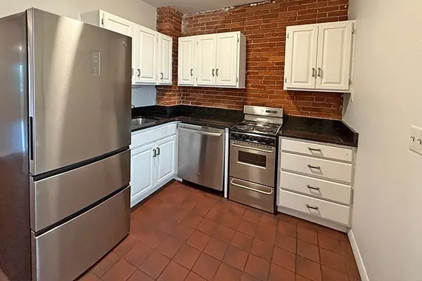 a kitchen with stainless steel appliances a refrigerator sink and cabinets