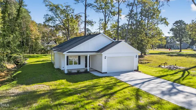 a view of a house with pool and a yard