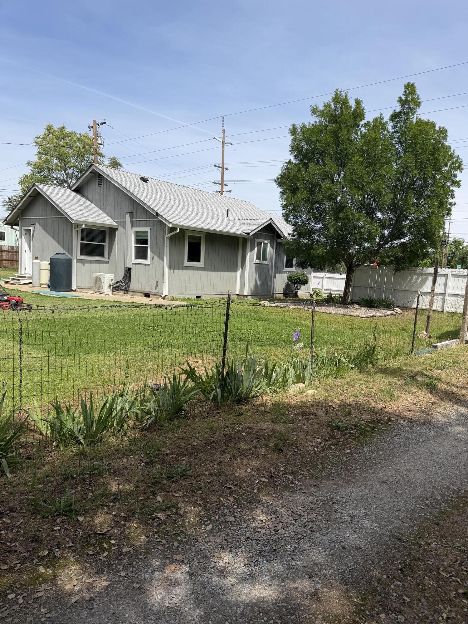 6200 Westside Road Redding, CA 96001 - Photo 32 of 50 a front view of a house with a yard and garage