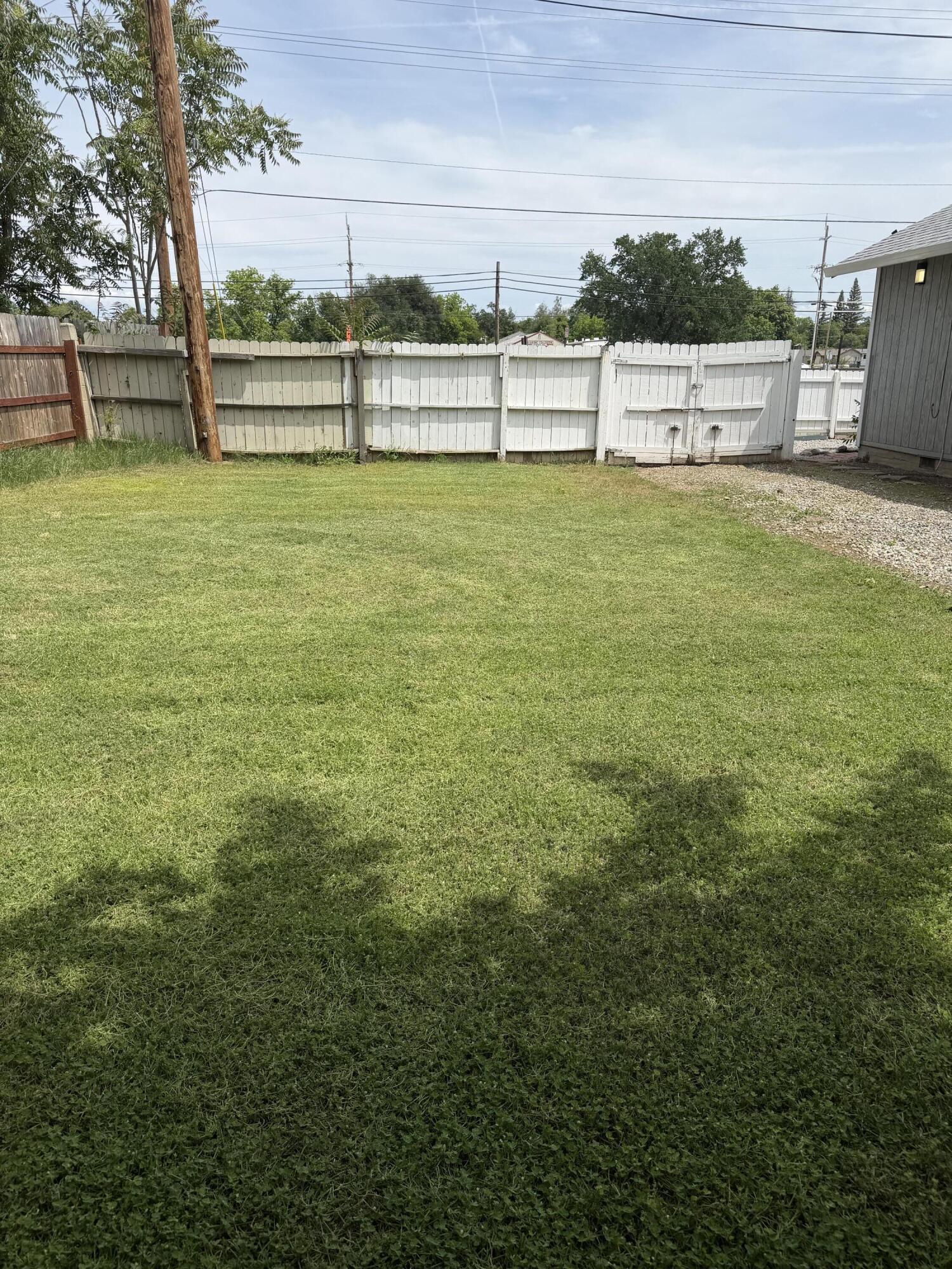 6200 Westside Road Redding, CA 96001 - Photo 35 of 50 a view of a yard with wooden fence