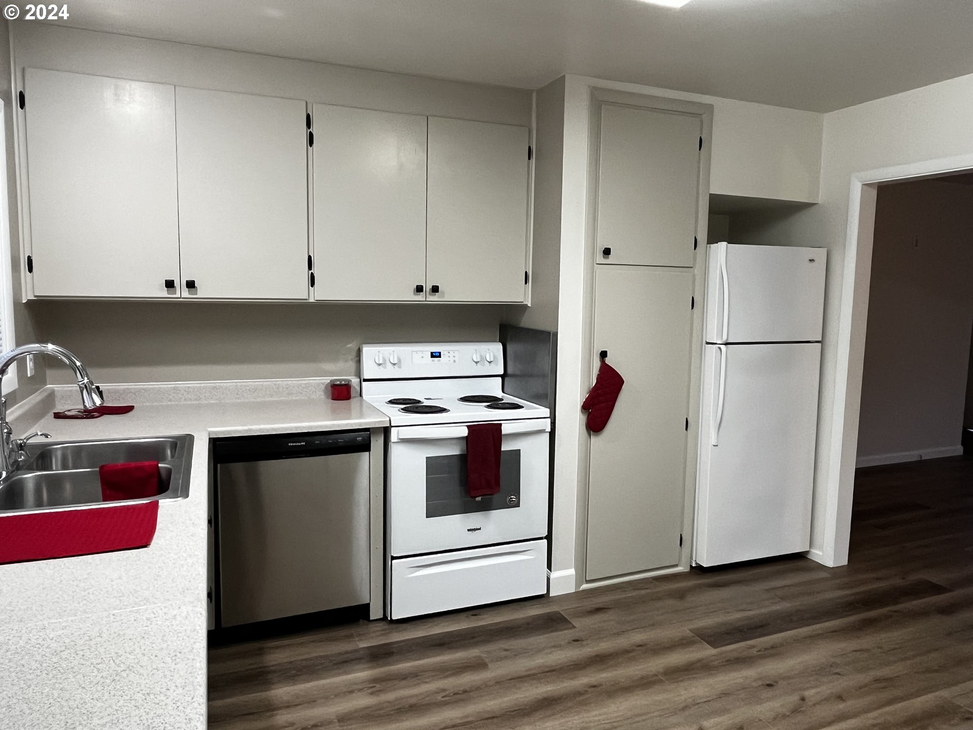 564 Nighthawk Lane Springfield, OR 97477 - Photo 11 of 13 a kitchen with stainless steel appliances white cabinets and white appliances