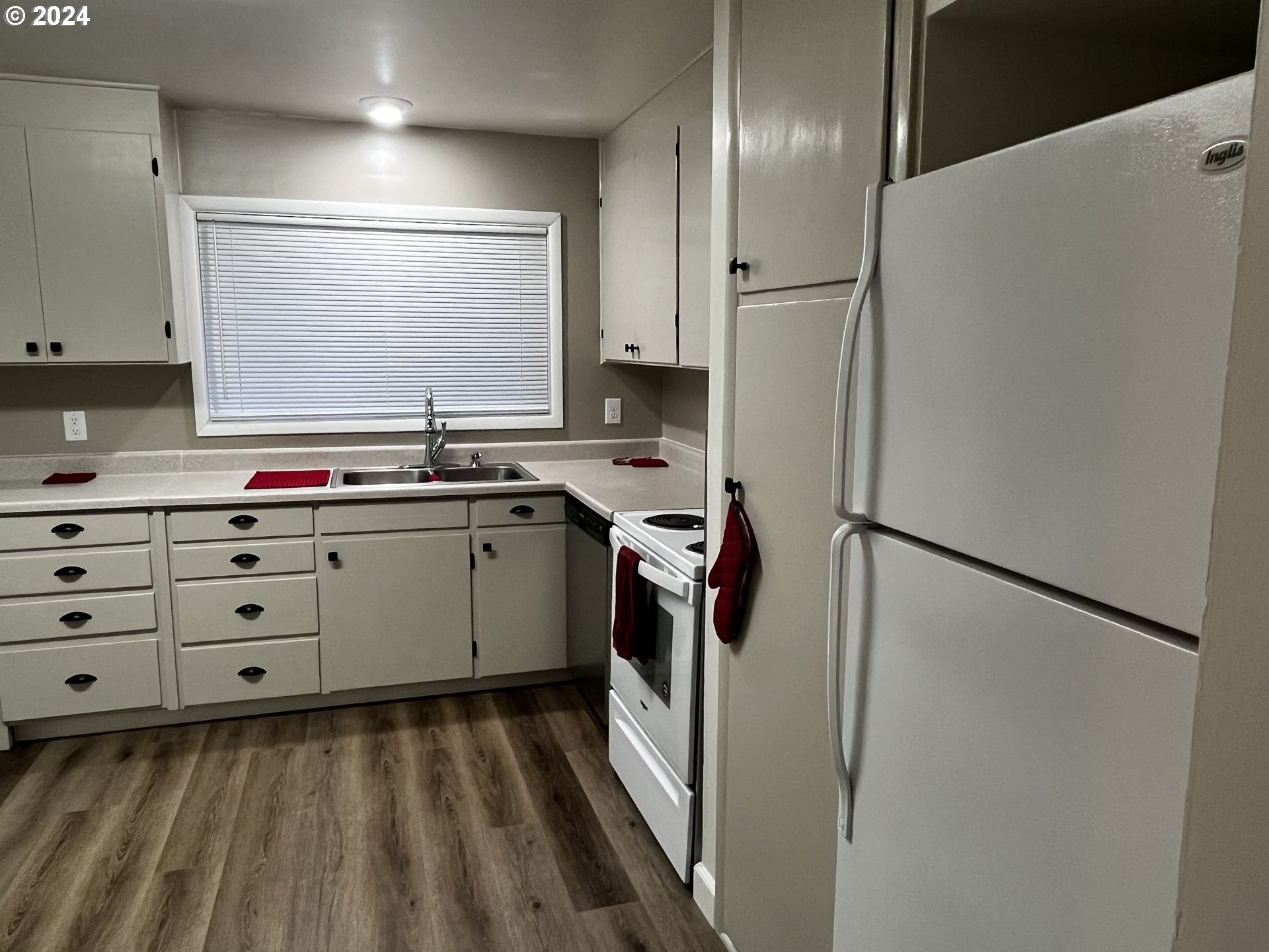 564 Nighthawk Lane Springfield, OR 97477 - Photo 8 of 13 a kitchen with a sink stainless steel appliances a refrigerator and cabinets
