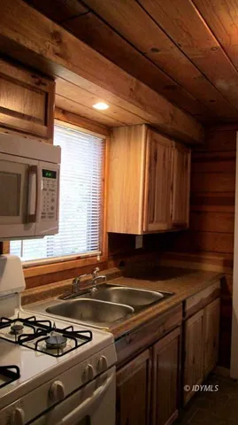 a kitchen with stove and cabinets