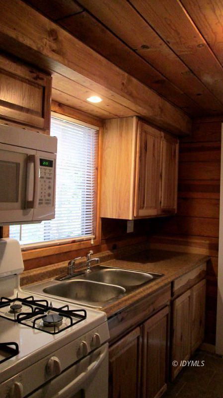 54100 Pine Crest Avenue, Unit 7 Idyllwild, CA 92549 - Photo 2 of 12 a kitchen with stove and cabinets