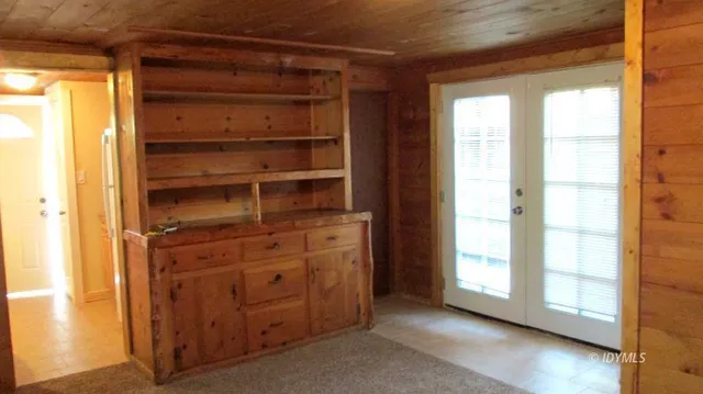 a hallway with cabinets and a wooden floor