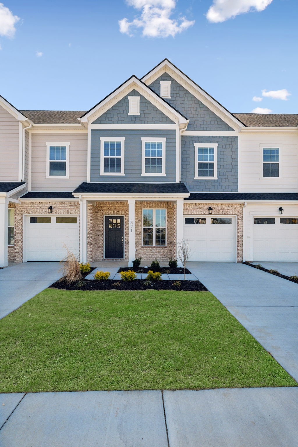a front view of a house with a garden