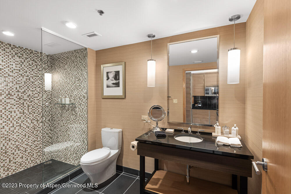 130 Wood Road, Unit 505 & 507 Snowmass Village, CO 81615 - Photo 12 of 35 a bathroom with a sink a toilet a mirror and shower