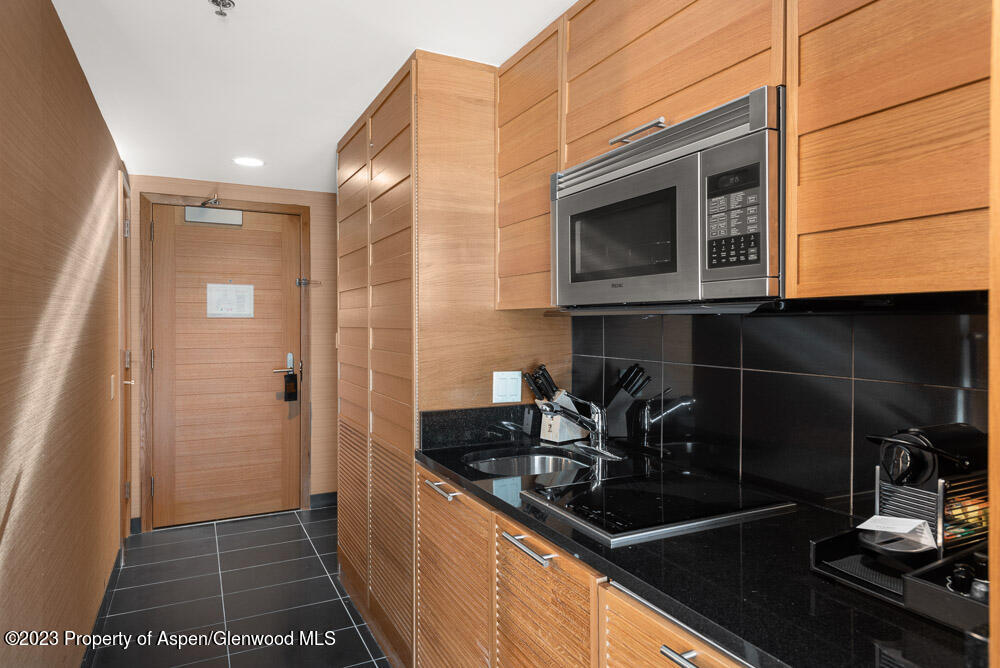 130 Wood Road, Unit 505 & 507 Snowmass Village, CO 81615 - Photo 7 of 35 a kitchen with a sink and cabinets