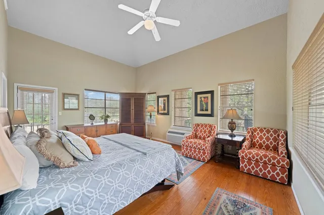 a bedroom with bed couch and window