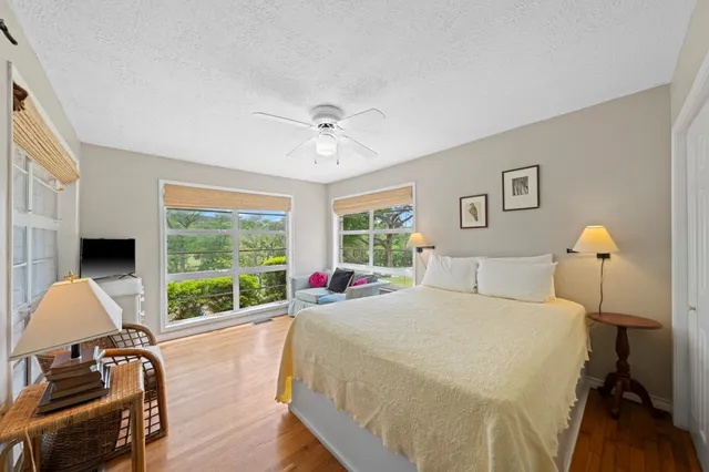 a spacious bedroom with a bed and a large window