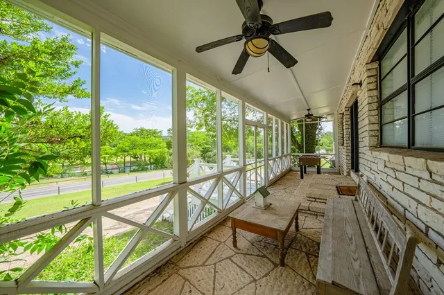 a view of a porch with furniture and a yard