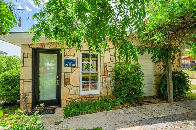 front view of a house with a tree