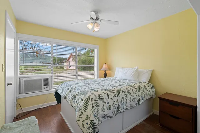 a bedroom with a bed and a window