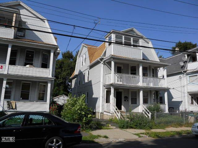 111 Smith Street Bridgeport, CT 06607 - Photo 1 of 1 a front view of a house with garden