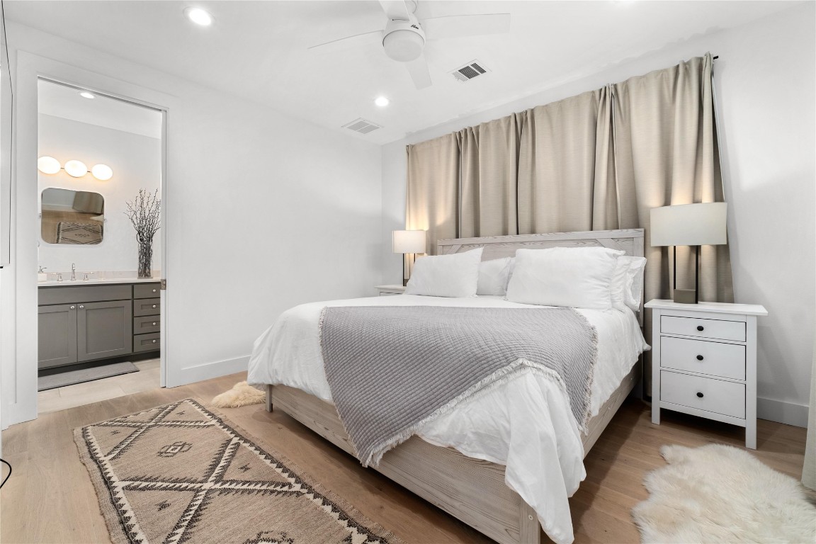 1806 Garden Street, Unit B Austin, TX 78702 - Photo 10 of 24 a bedroom with a large bed and a chandelier