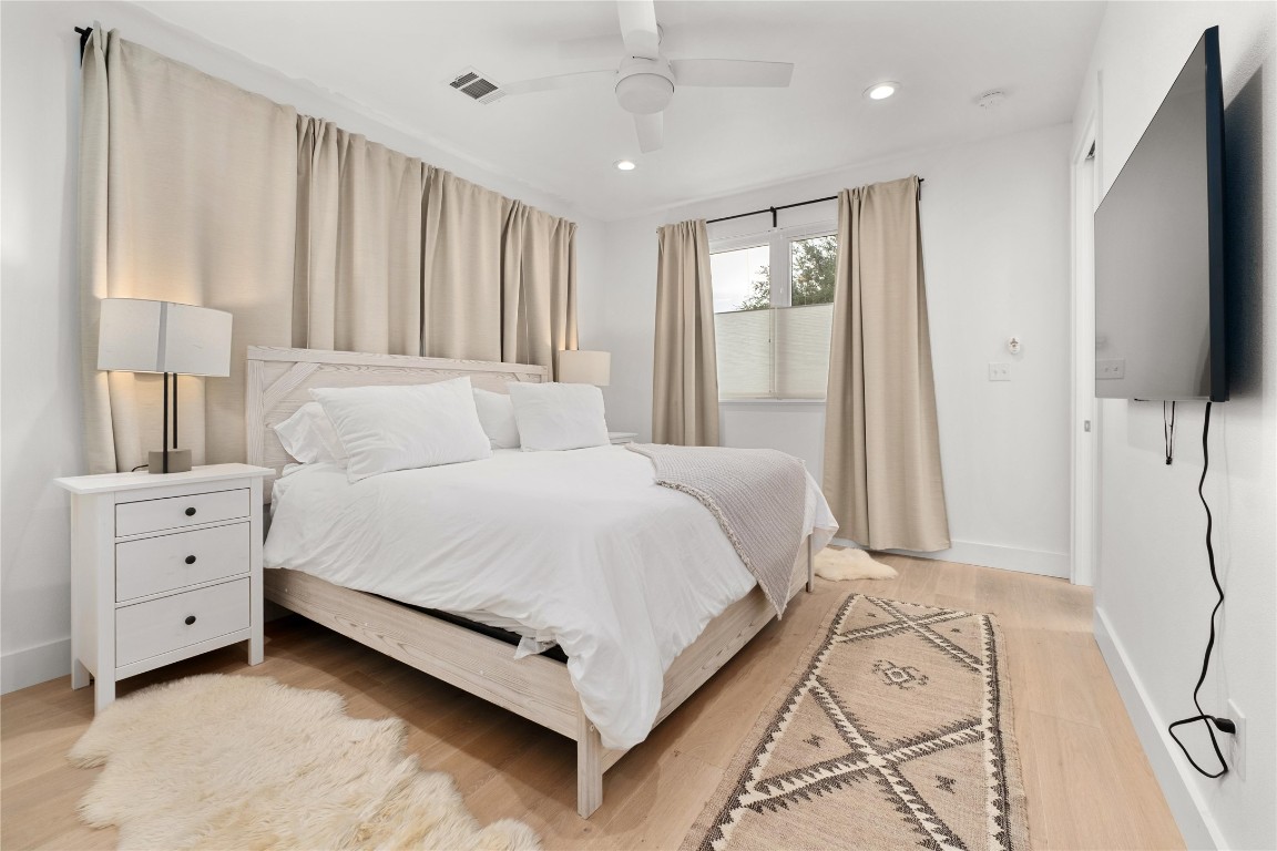 1806 Garden Street, Unit B Austin, TX 78702 - Photo 11 of 24 a bed room with a bed and a flat tv screen