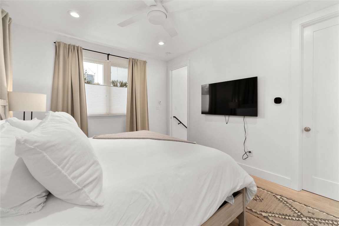1806 Garden Street, Unit B Austin, TX 78702 - Photo 12 of 24 a bedroom with a bed tv and a window