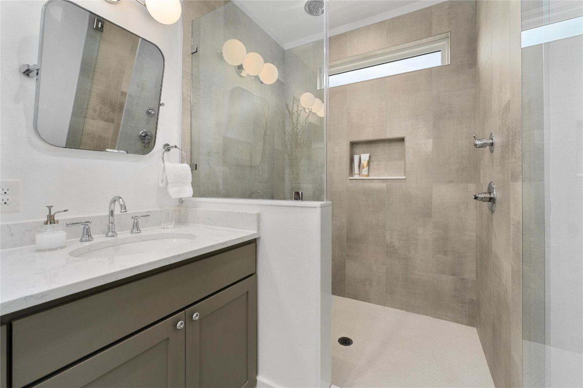 1806 Garden Street, Unit B Austin, TX 78702 - Photo 15 of 24 a bathroom with a granite countertop sink mirror and a