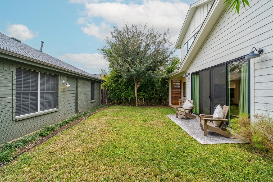 1806 Garden Street, Unit B Austin, TX 78702 - Photo 21 of 24 a view of a backyard with table and chairs and wooden fence
