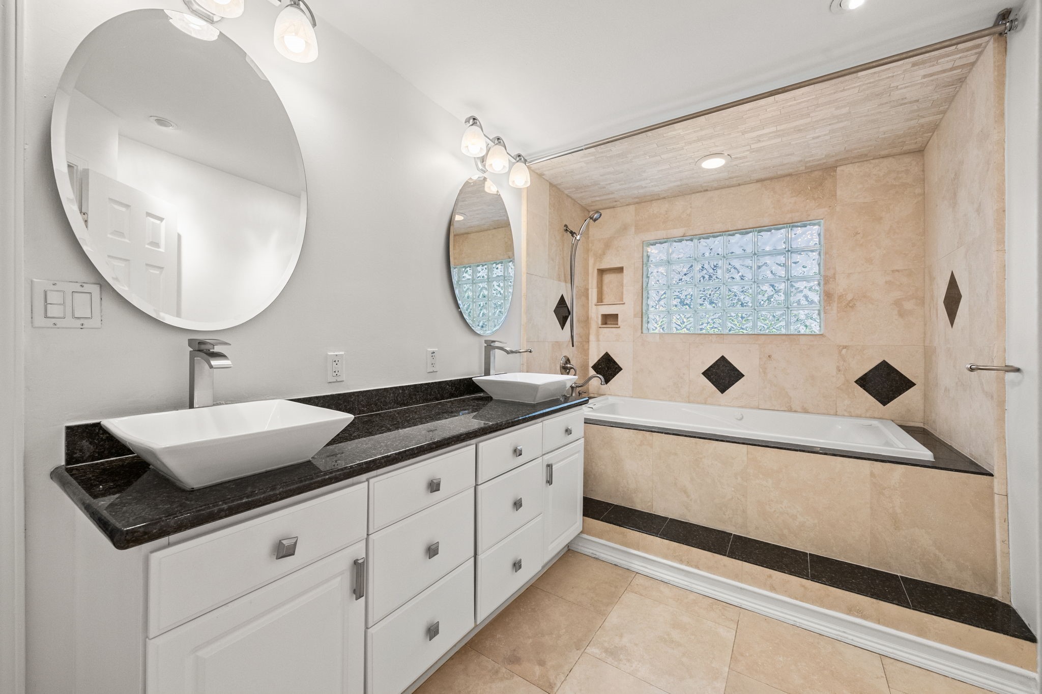 10310 Mayfield Road Houston, TX 77043 - Photo 27 of 49 Primary bath has travertine floors, 2 sinks, combo jacuzzi and shower