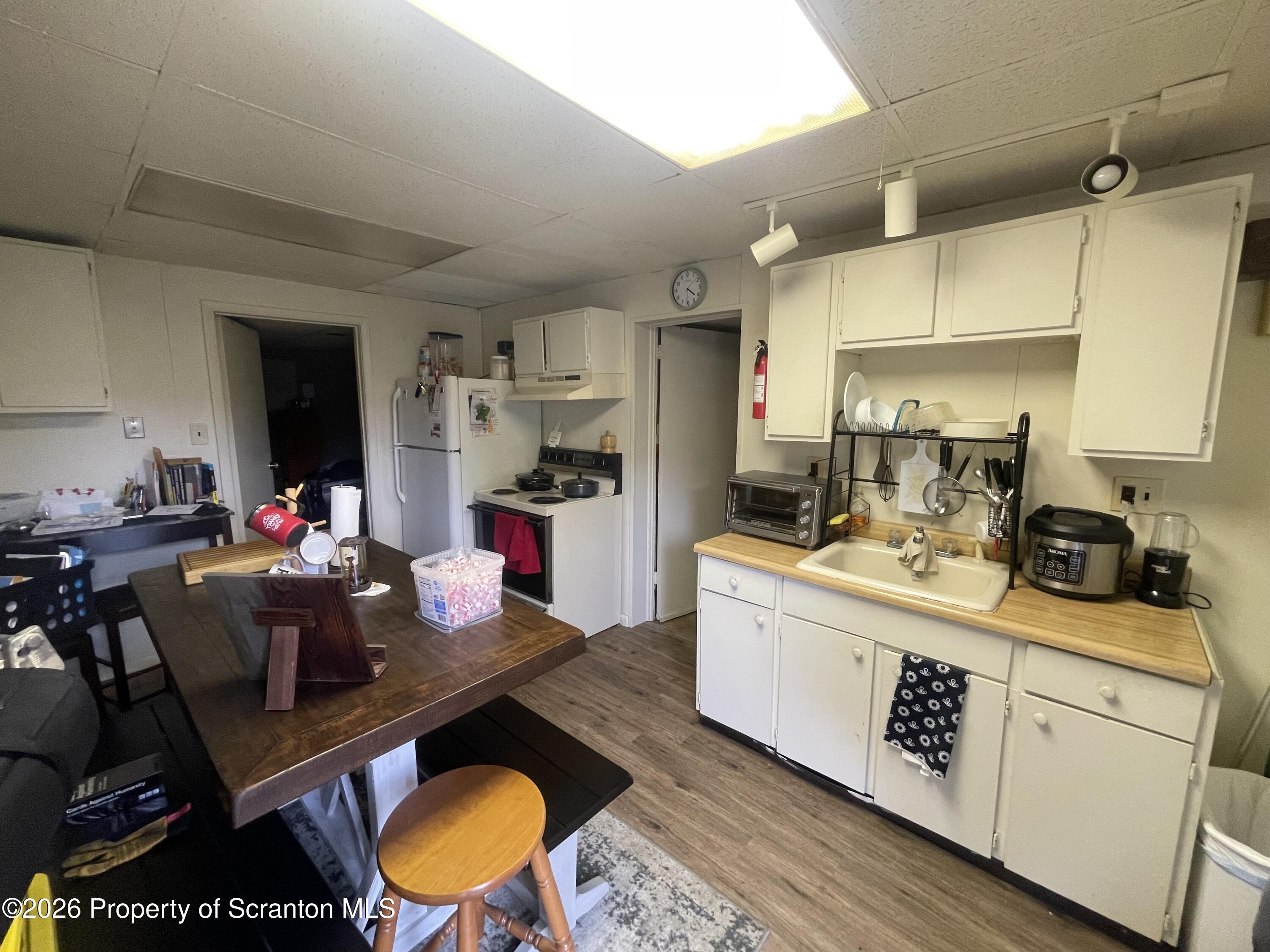 238 George Street Moosic, PA 18507 - Photo 22 of 23 a kitchen with stainless steel appliances granite countertop a stove and white cabinets