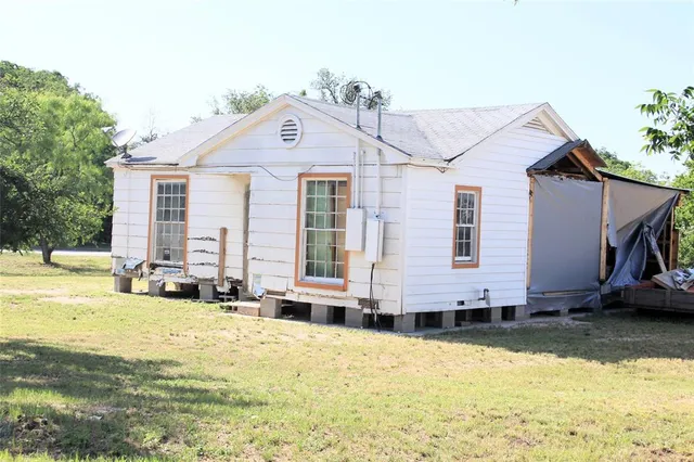 a view of a house with swimming pool and sitting area