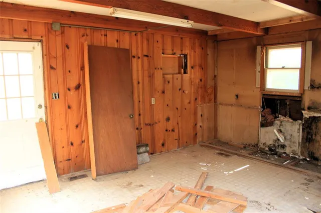 an empty room with windows and table