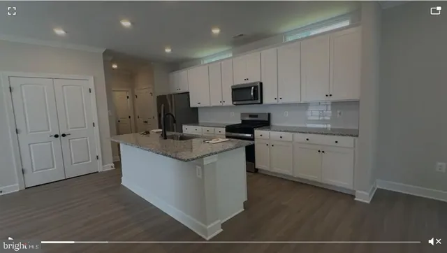 a kitchen with a sink window and cabinets