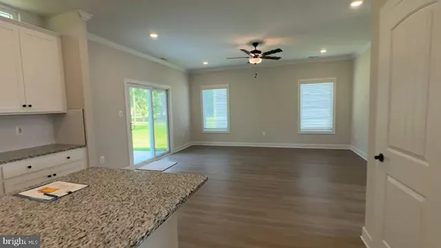 a bathroom with a granite countertop sink a toilet and mirror