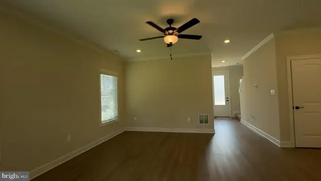 a view of a livingroom with a ceiling fan and window