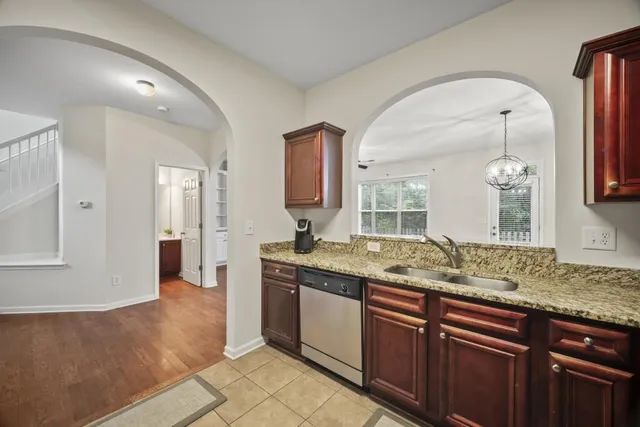 a bathroom with a granite countertop sink two mirror and shower