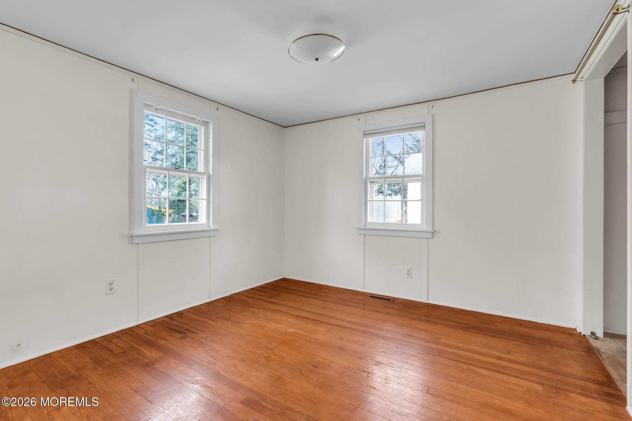 2609 River Road Manasquan, NJ 08736 - Photo 18 of 28 wooden floor in an empty room with a window