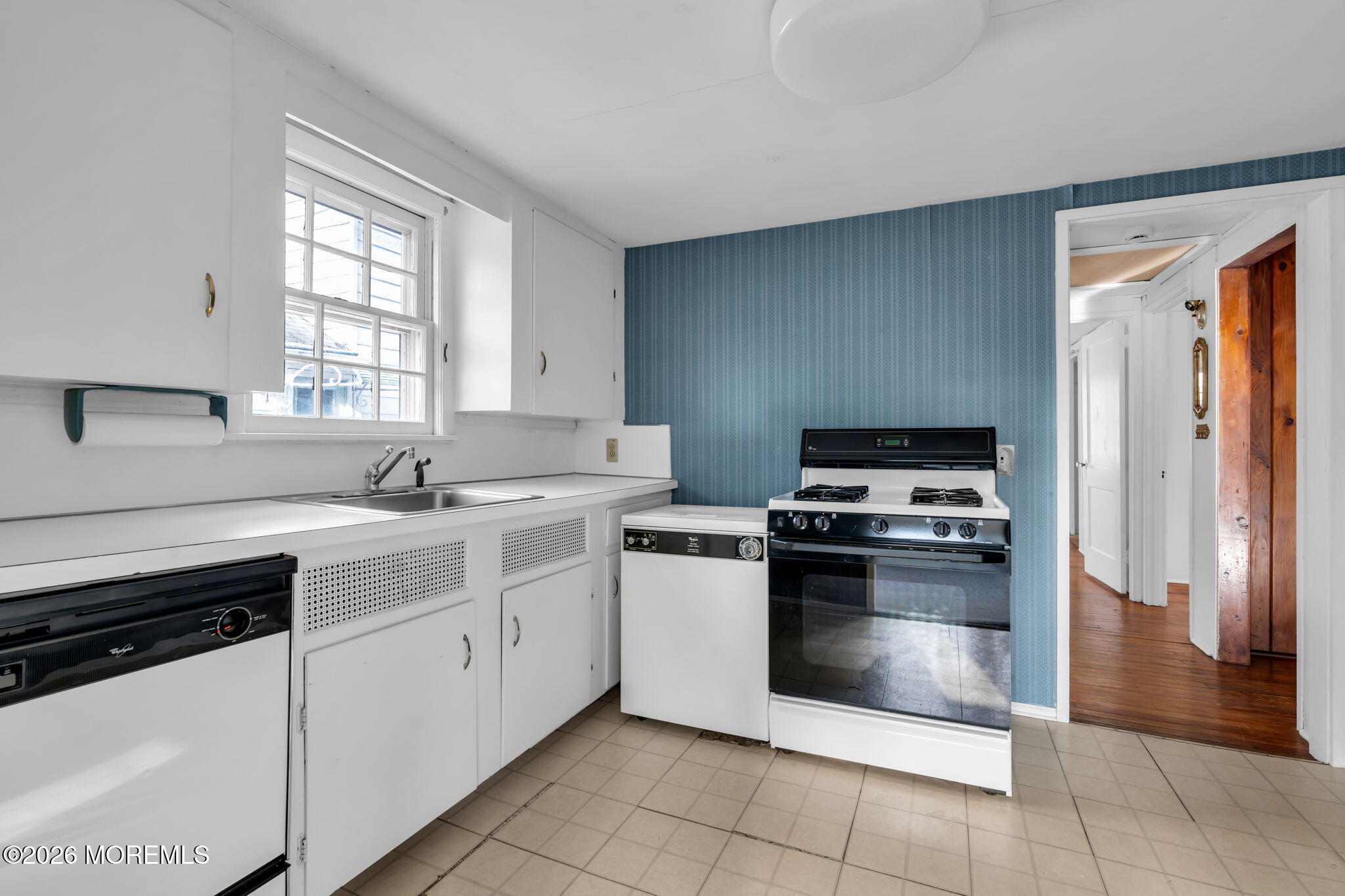 2609 River Road Manasquan, NJ 08736 - Photo 20 of 28 a kitchen with white cabinets and appliances