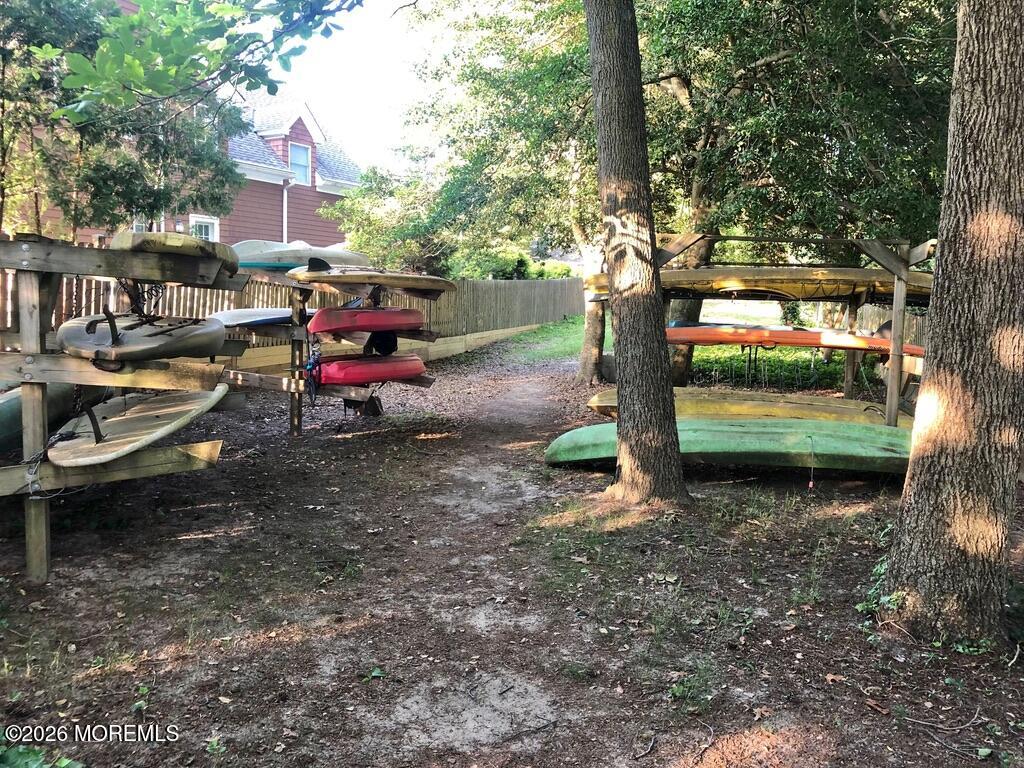 2609 River Road Manasquan, NJ 08736 - Photo 6 of 28 a backyard of a house with barbeque oven fire pit table and chairs