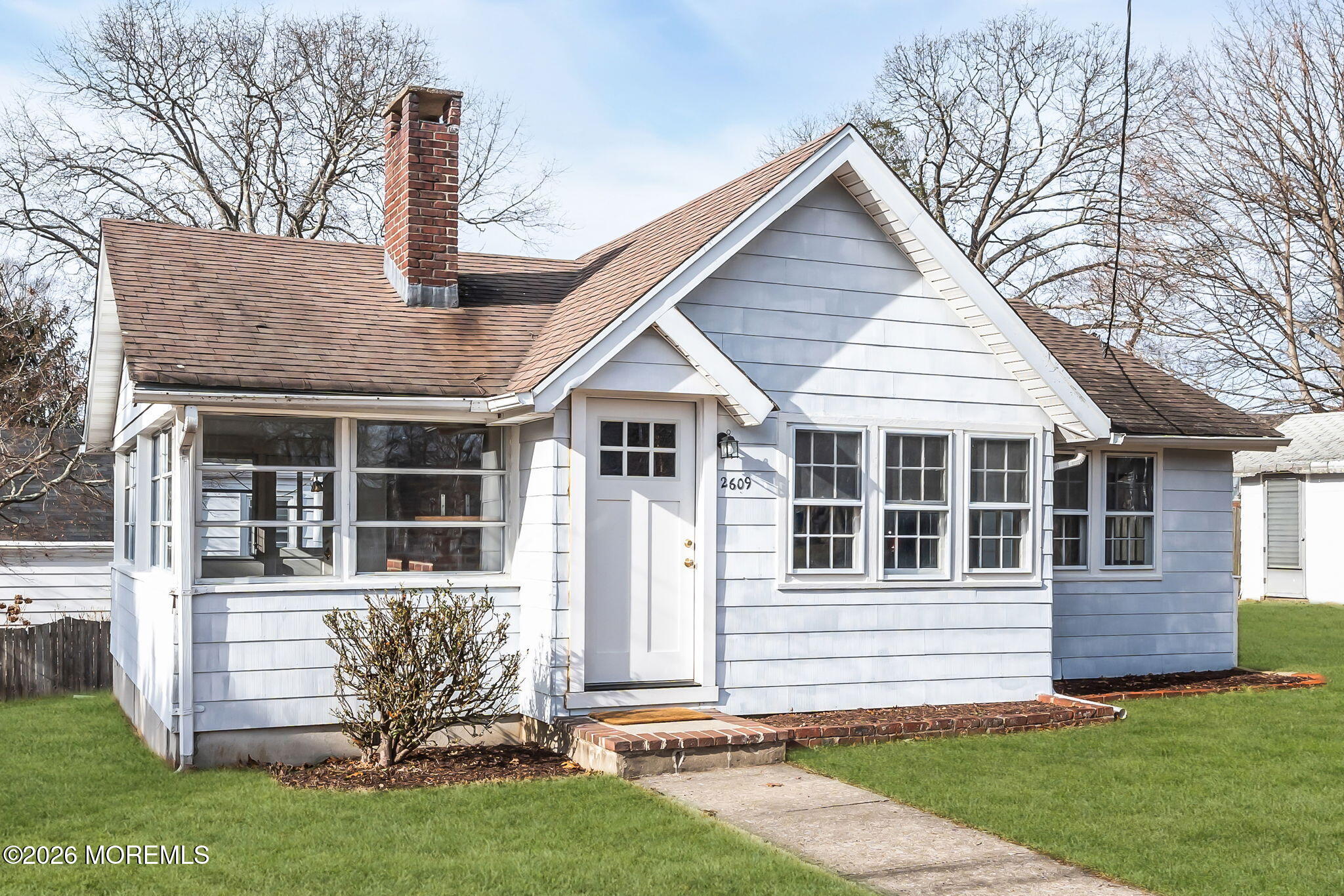 2609 River Road Manasquan, NJ 08736 - Photo 7 of 28 a front view of a house with a yard table and chairs