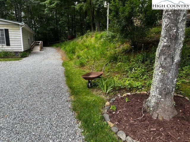 1426 Rainbow Trail Boone, NC 28607 - Photo 28 of 48 a backyard of a house with a yard and outdoor seating