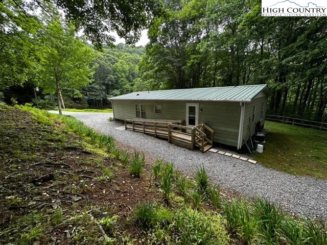 1426 Rainbow Trail Boone, NC 28607 - Photo 41 of 48 a view of a wooden house with a yard