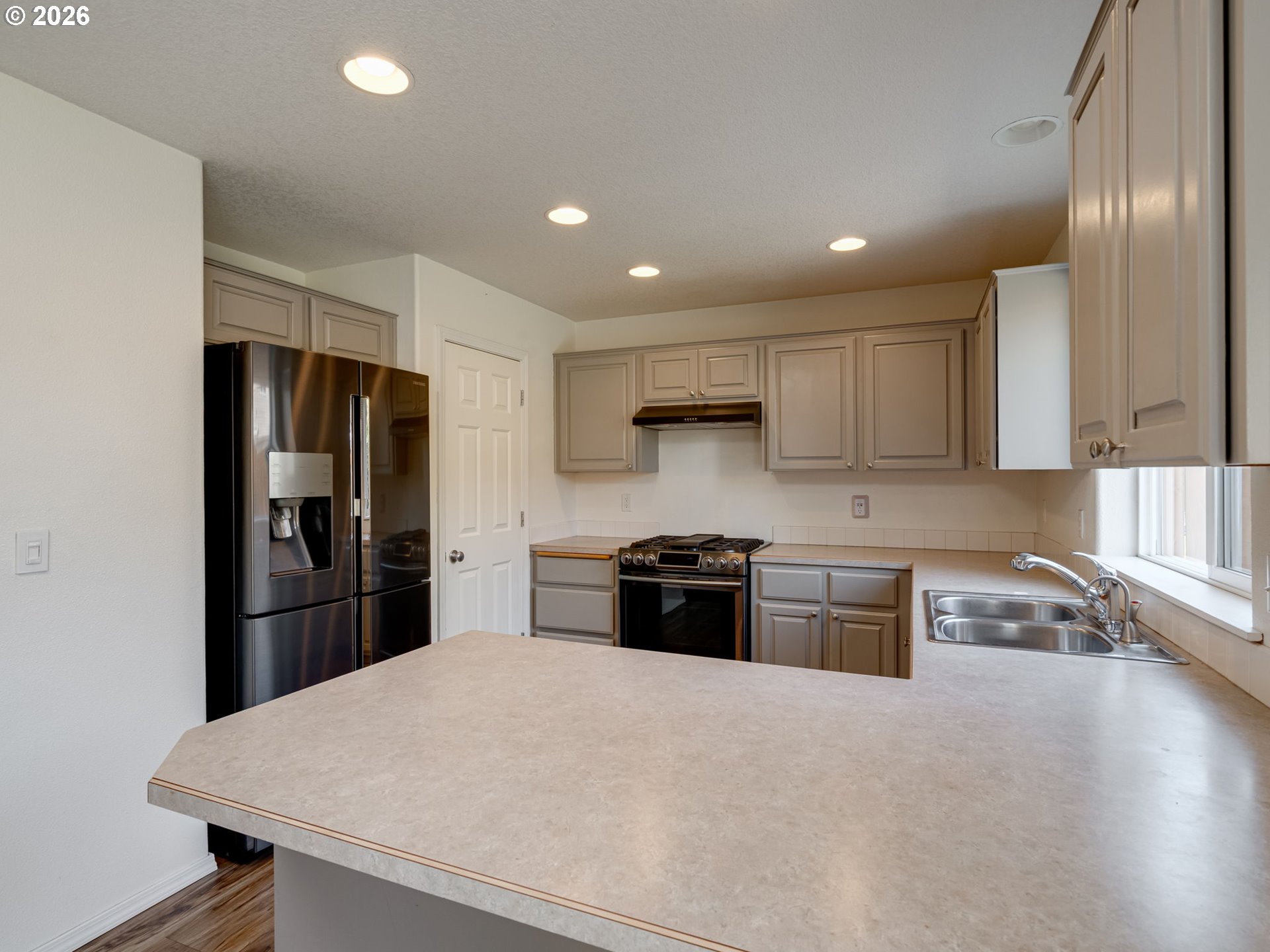 1312 Northwest 9th Way Battle Ground, WA 98604 - Photo 15 of 39 a kitchen with stainless steel appliances granite countertop a refrigerator stove microwave and sink