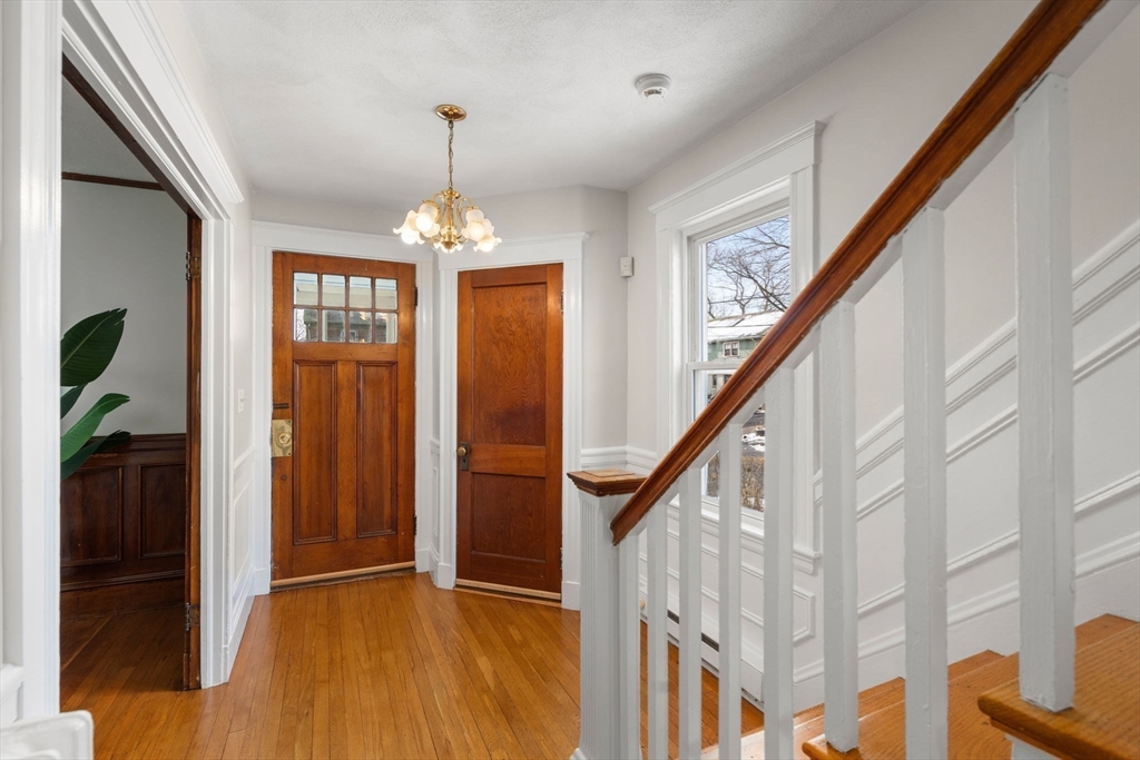 89 Coolidge Road Arlington, MA 02476 - Photo 12 of 22 a view of an entryway with wooden floor and stairs