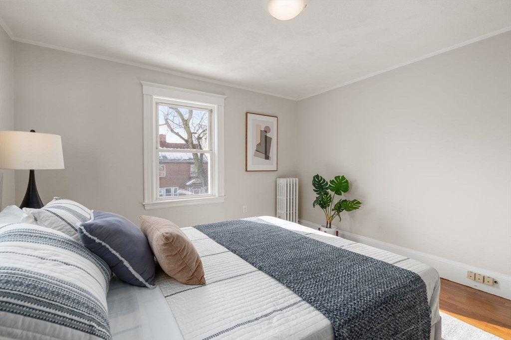 89 Coolidge Road Arlington, MA 02476 - Photo 14 of 22 a bedroom with a bed and a window