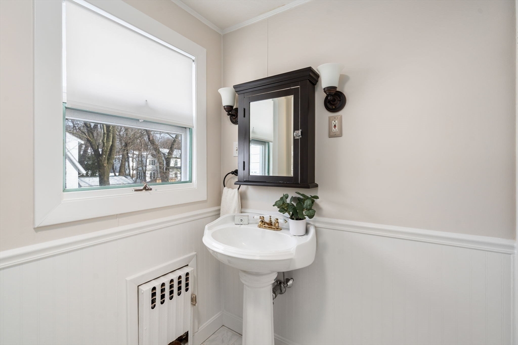 89 Coolidge Road Arlington, MA 02476 - Photo 17 of 22 a bathroom with a sink and a mirror