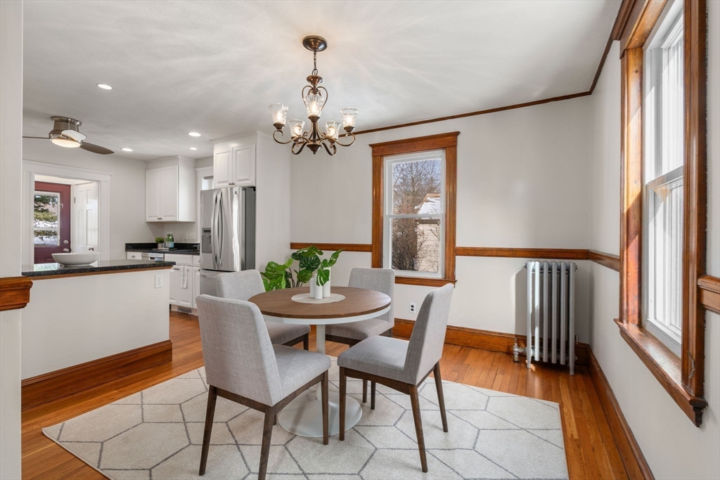 89 Coolidge Road Arlington, MA 02476 - Photo 6 of 22 a view of a dining room with furniture and a chandelier