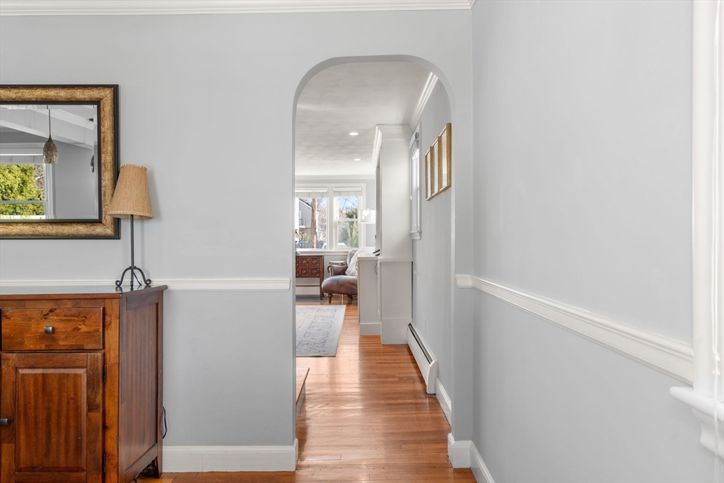 64 Newfield Street Boston, MA 02132 - Photo 11 of 36 a view of a hallway with wooden floor and a bathroom