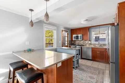 a kitchen with a table chairs sink and cabinets